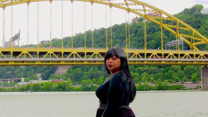 Ciora Thomas stands along the riverbank where she occasionally slept as a homeless trans youth. This year, she incorporated