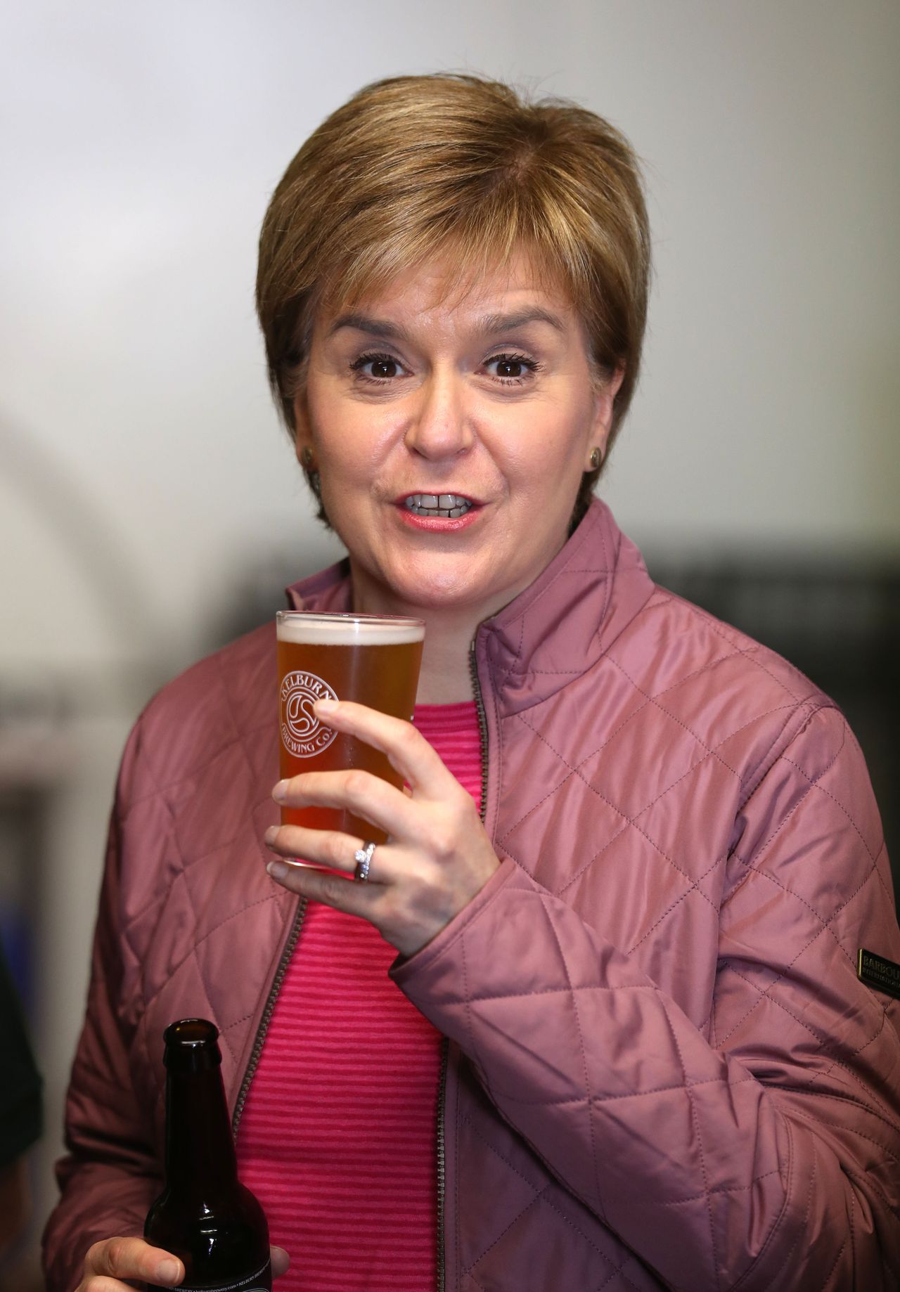 Scotland First Minister Nicola Sturgeon holds a pint of beer during a visit to Kelburn Brewery, in Barrhead, East Renfrewshire