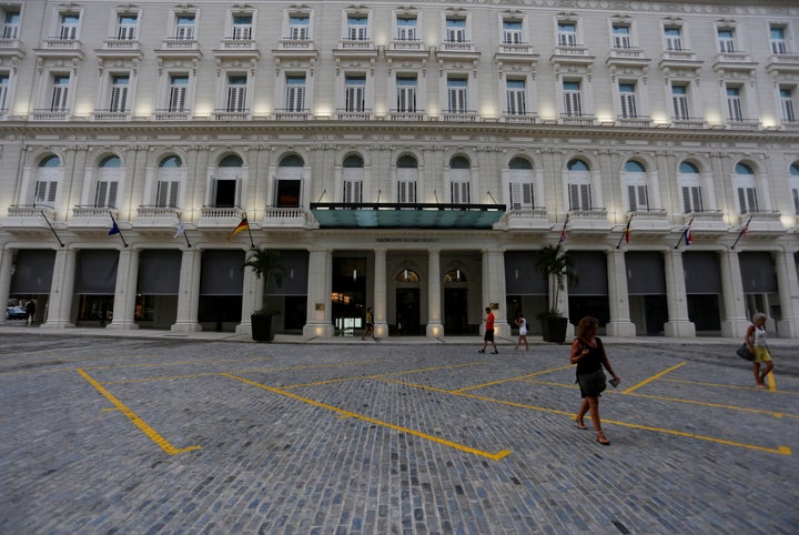 People walk past a renovated Belle Epoque shopping mall, now housing the Gran Hotel Manzana in the top floors and luxury stores on the ground floor.