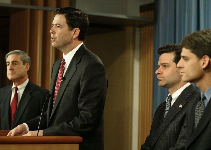 In this 2004 file photo, then-FBI Director Robert Mueller, then-Deputy Attorney General James B. Comey and then-Assistant Attorney General Christopher Wray of the Criminal Division stand with then-SEC Director of Enforcement Steve Cutler to speak about the Enron investigation during a news conference.