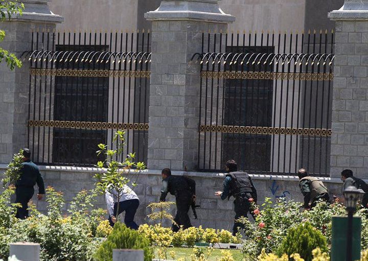 Members of Iranian forces run during an attack on the Iranian parliament in central Tehran, Iran, June 7, 2017.