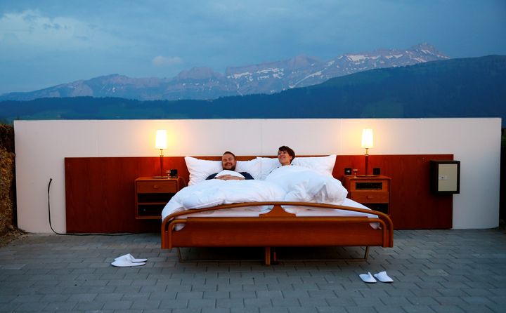 A couple pose as first guests in the bedroom of the Null-Stern-Hotel, which can be reserved by the public. 