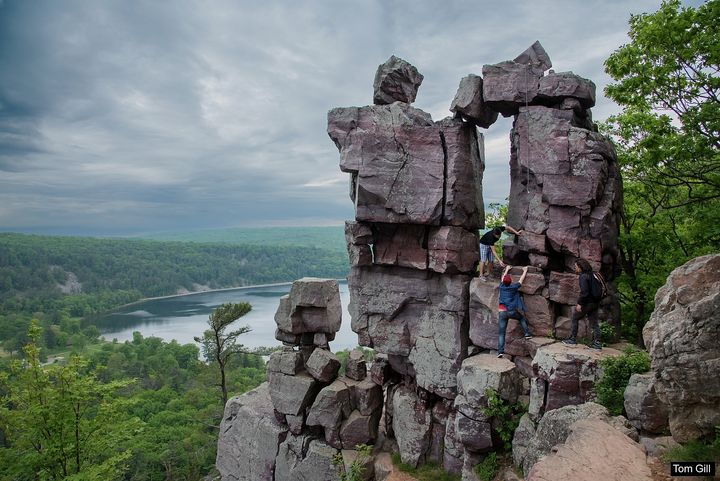 A group of hikers climbing into Devil’s Doorway.