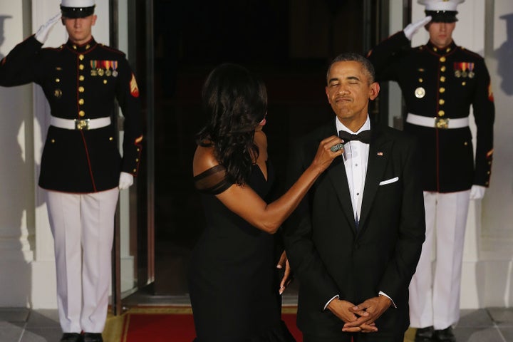 First Lady Michelle Obama straightens U.S. President Barack Obama's tie while they wait on the North Portico for the arrival of Chinese President Xi Jinping and his wife Madame Peng Liyuan ahead of a state dinner at the White House September 25, 2015 in Washington, DC. 