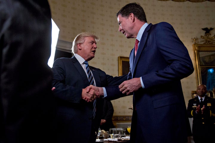 President Trump shakes hands with James Comey during an Inaugural Law Enforcement Officers and First Responders Reception at