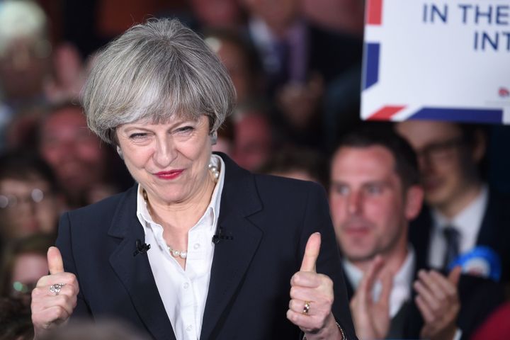 Theresa May gives the thumbs up after praise from activists