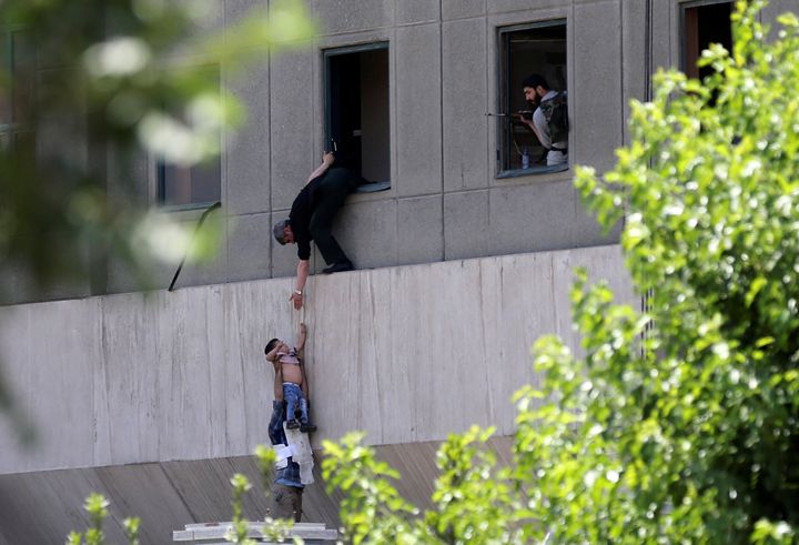 A boy is evacuated during a terror attack on the Iran's Parliament in central Tehran on June 7, 2017.