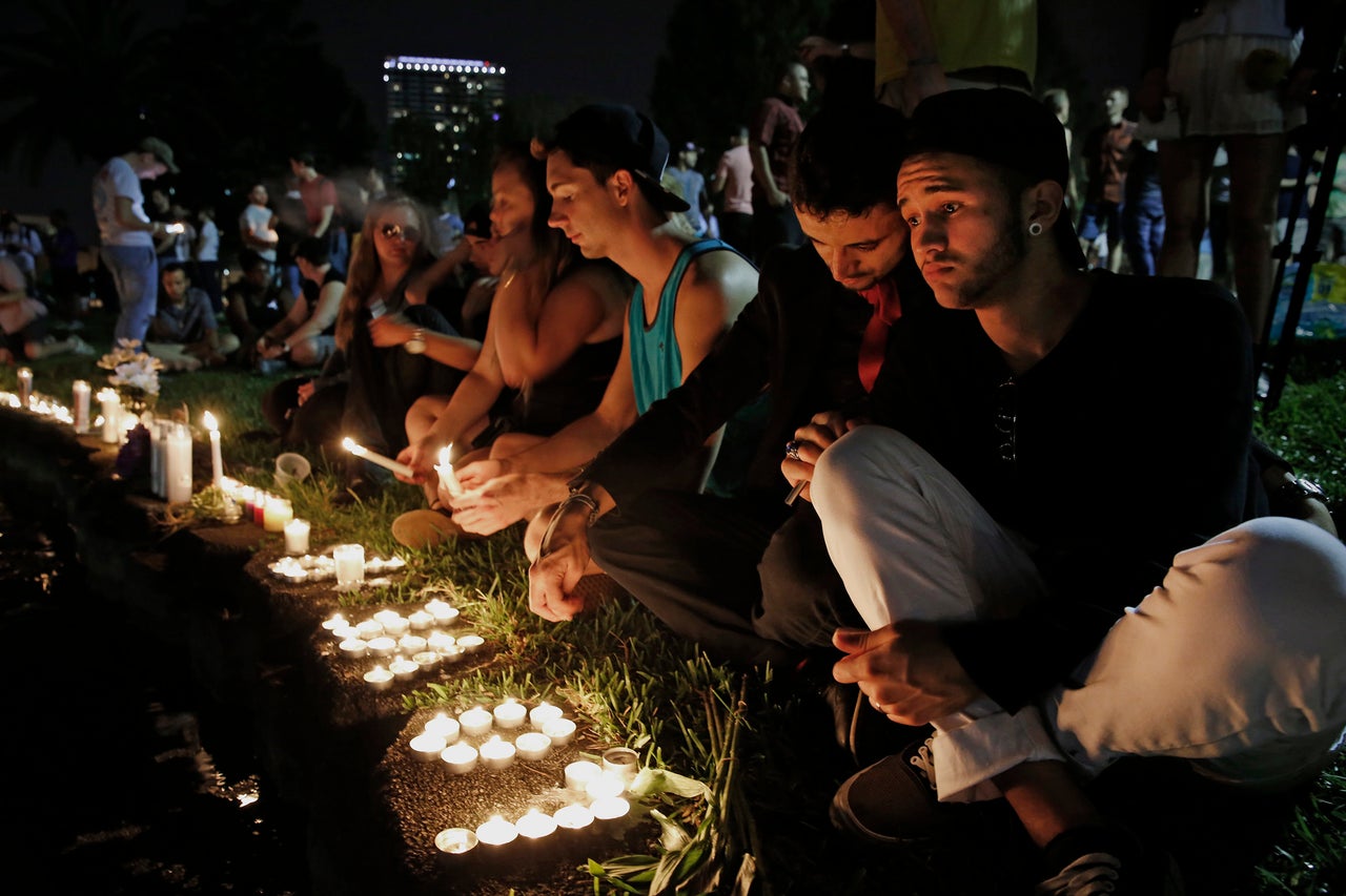 ORLANDO, FL - JUNE 12: Johnpaul Vazquez, right, and his boyfriend Yazan Sale, sit by Lake Eola, in downtown Orlando.