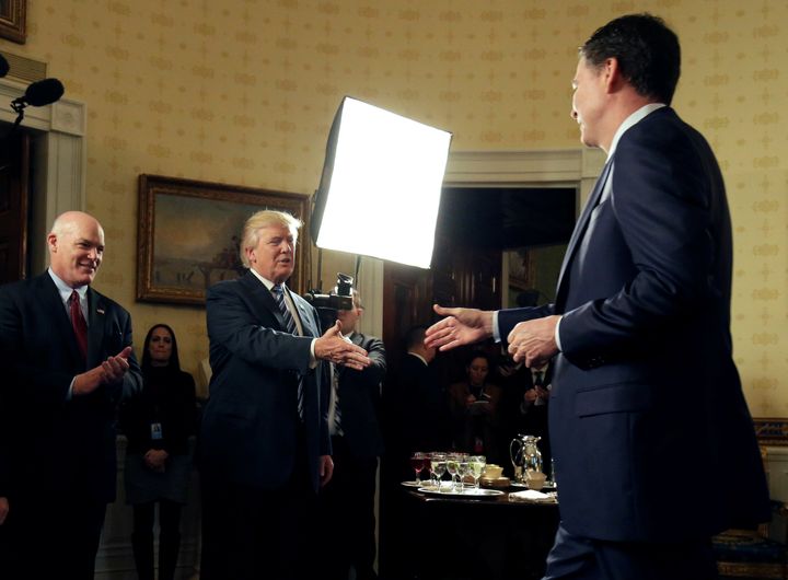 President Donald Trump greets FBI Director James Comey at the Inaugural Law Enforcement Officers and First Responders Reception in the Blue Room of the White House on Jan. 22.