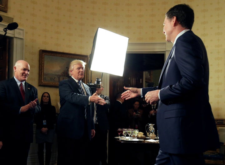 President Donald Trump greets FBI Director James Comey at the Inaugural Law Enforcement Officers and First Responders Recepti