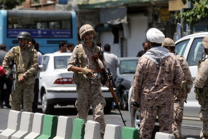 Members of the Iranian Revolutionary Guard secure an area outside the Iranian parliament.