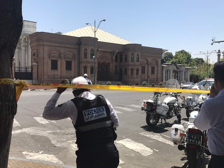 Police take security measures at the scene after gunmen opened fire at Iran's parliament and at the shrine of Ayatollah Ruhollah Khomeini in Tehran.