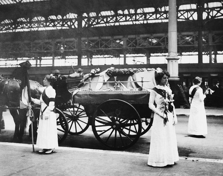 Suffragettes stand with the coffin of their fellow campaigner Emily Davison at Victoria Station in 1913