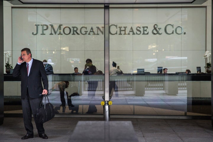 A man stands outside JP Morgan Chase's corporate headquarters on August 12, 2014 in New York City. U.S. banks announced second quarter profits of more than $40 billion, showing strong signs of a recovering economy. (Photo by Andrew Burton/Getty Images)