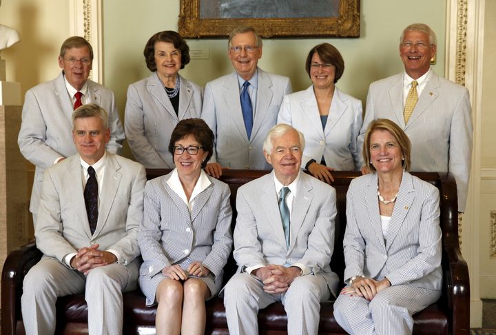 Dressed in their seersucker suits, Senators pose for a photo celebrating National Seersucker Day in the U.S. Capitol in Washington June 11, 2015.