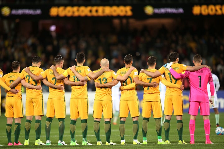 Australia's national team stands linked and at attention during the moment of silence.