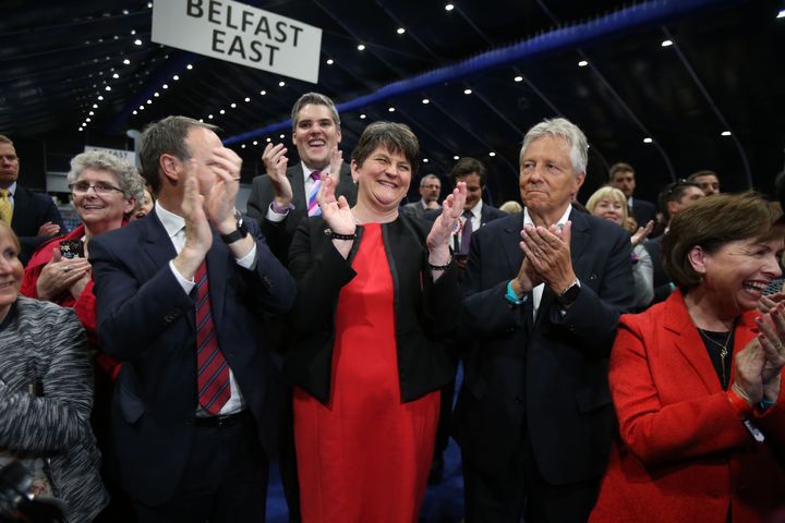 L-R: DUP deputy leader Nigel Dodds, leader Arlene Foster and former leader Peter Robinson cheer a DUP candidate's victory in Belfast
