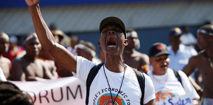 Protesters march past the venue for the World Economic Forum on Africa 2017 meeting in Durban, South Africa.