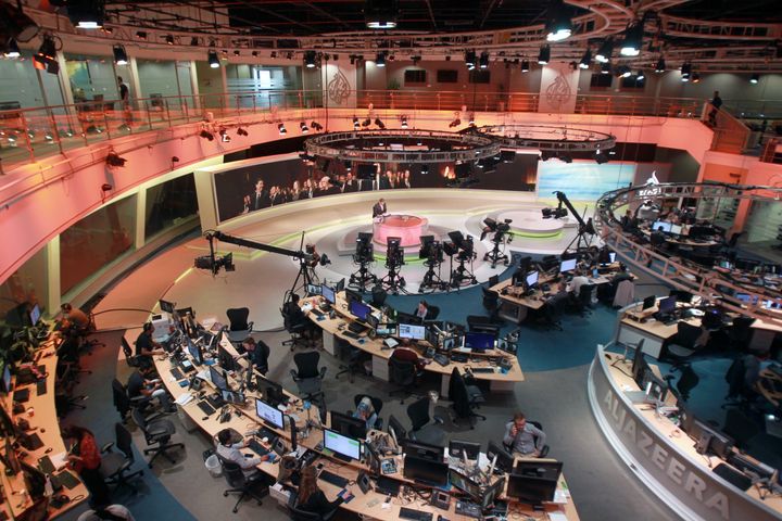 Staff work inside the headquarters of Al Jazeera Network, in Doha, Qatar, on Thursday.