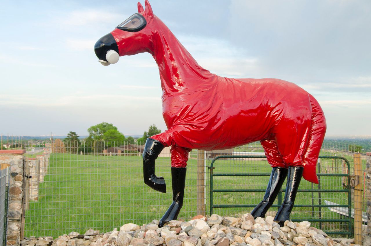 Artist Jeff Gipe's sculpture "Cold War Horse" -- complete with a gas mask and bright red hazmat suit -- overlooks Rocky Flats from the south. An inscription nearby reads, "This memorial stands as a reminder for a history that we must not forget."