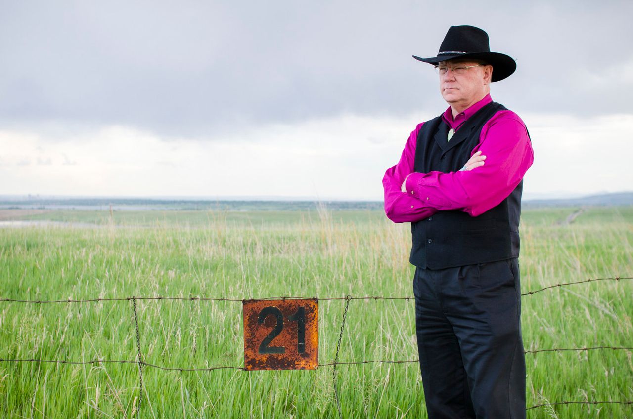 Jon Lipsky, the retired FBI agent who led the raid on Rocky Flats on June 6, 1989, stands along the fence at the refuge's northern border.