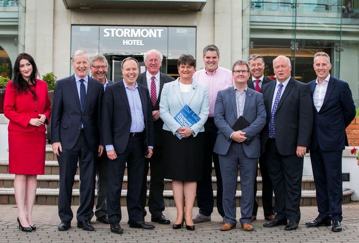 DUP leaders Arlene Foster, center, stands with newly elected Members of Parliament in Belfast, Northern Ireland, on Friday.