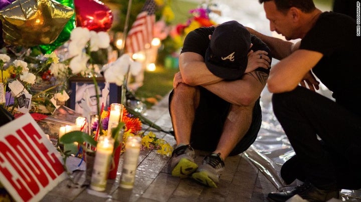 <p>Jean Dasilva, left, if comforted by Felipe Soto as they morn the loss of their friend Javier-Reyes on June 14, 2016. (source: CNN)</p>