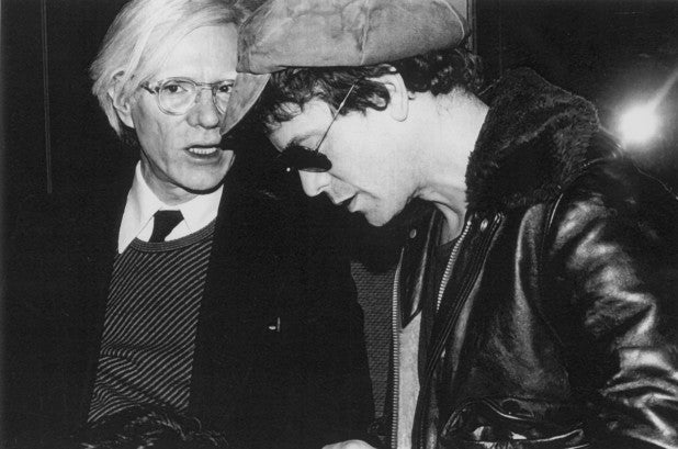 Andy Warhol conferring with Lou Reed.