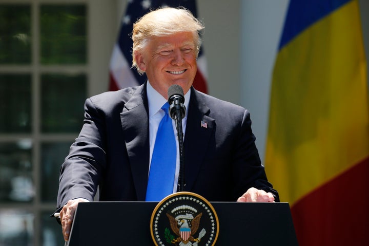President Donald Trump reacts to a reporter's question during a joint news conference with Romanian President Klaus Iohannis
