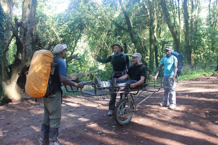 With no hospitals on Kilimanjaro, it is a bumpy ride down on a wheelbarrow stretcher