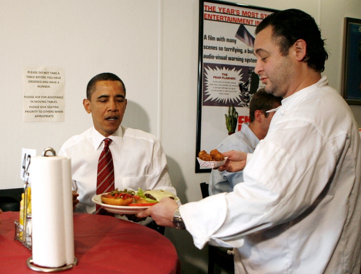 Former President Barack Obama receives his "fancy" lunch order at Ray's Hell Burger in Arlington, Virginia, in May 2009.