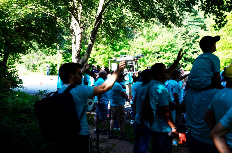 A young member of LLC points a drone to in the direction of the clinic. The use of drones outside private property