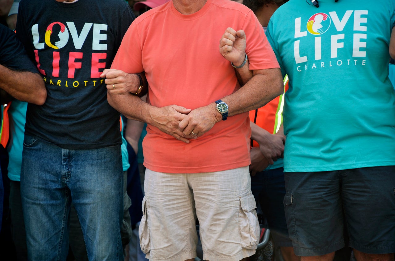 Members of Love Life Charlotte pray together outside of the abortion clinic. 