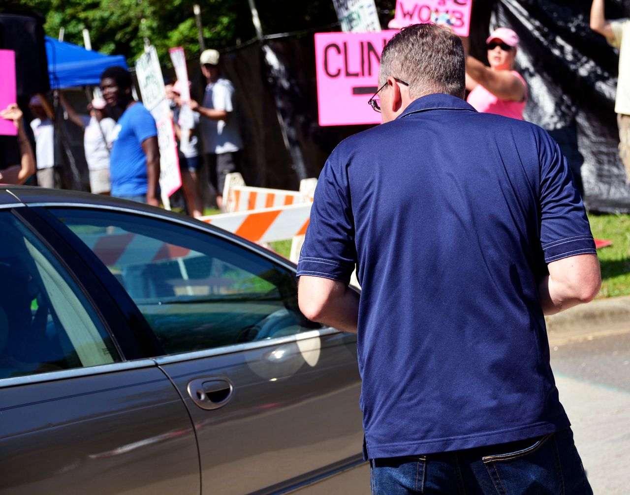 An anti-abortion protester from Cities4Life attempts to engage with a patient outside the center.