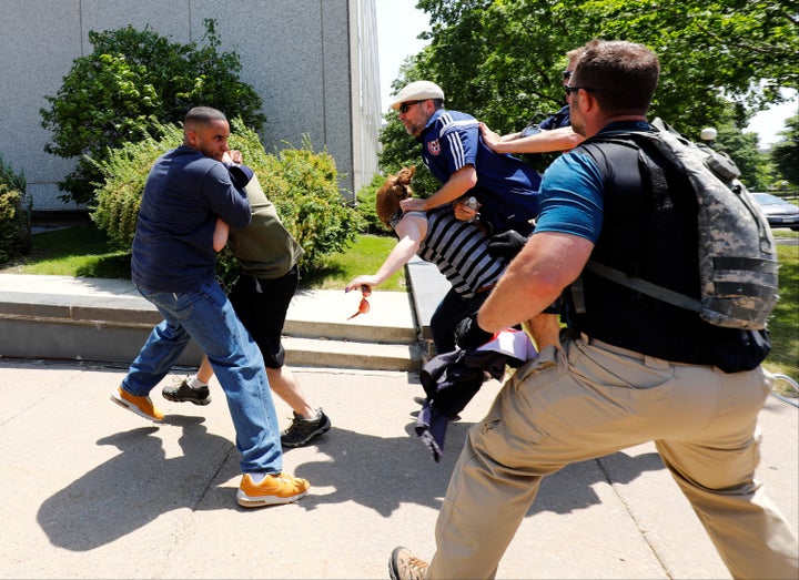 Anti-sharia protesters scuffle with counter-demonstrators and members of the Minnesota State Patrol at the state capitol in S