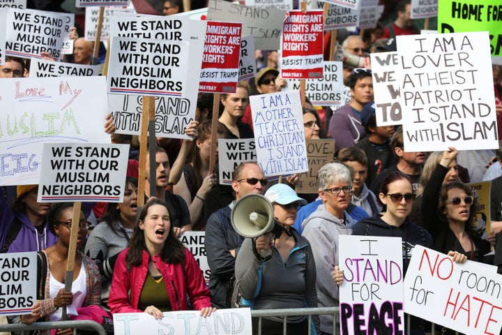 Counter-protesters hold signs and shout slogans during an anti-Sharia rally in Seattle, Washington, U.S., June 10, 2017.