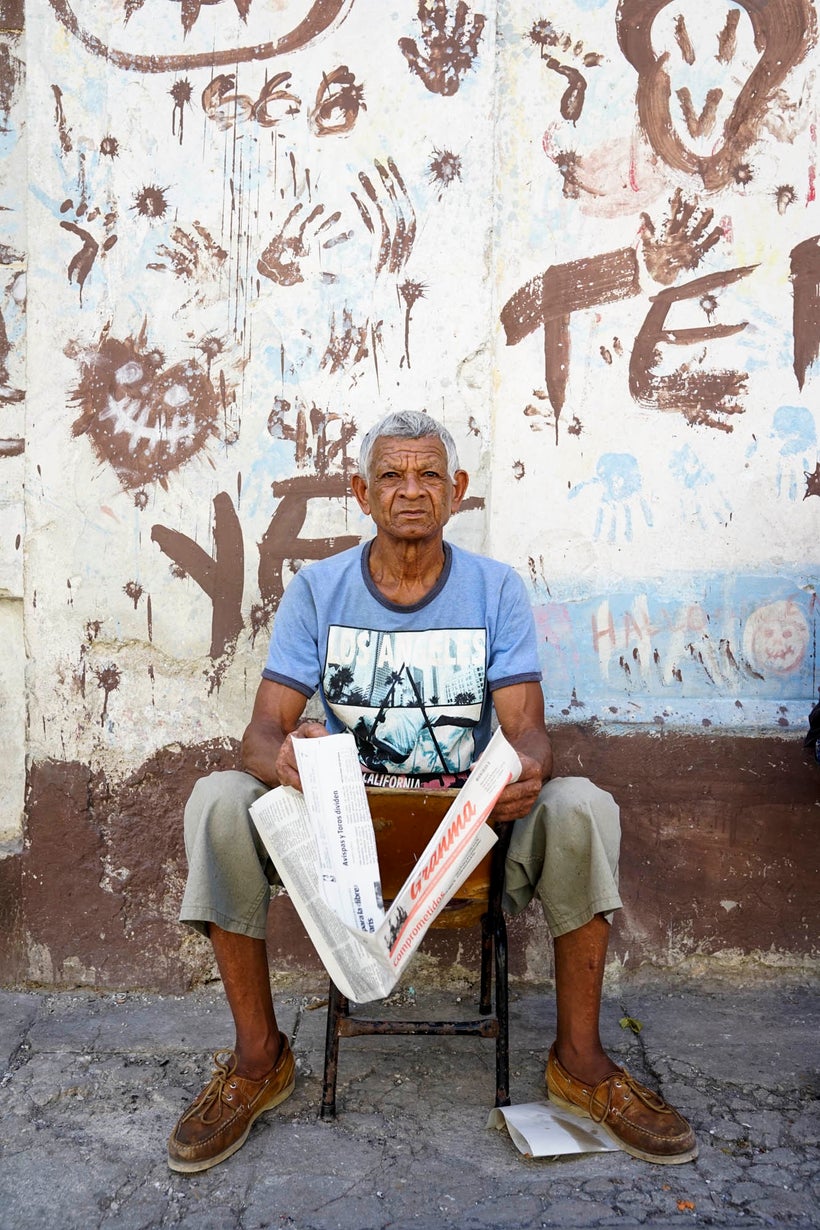 This man was really not happy with me taking his photo. At first he was reading the paper, and then as I continued to take ph
