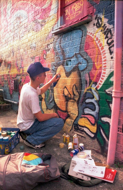 Street artist Cheo is pictured here painting at the Barton Hill Youth Centre in Bristol in 1989.