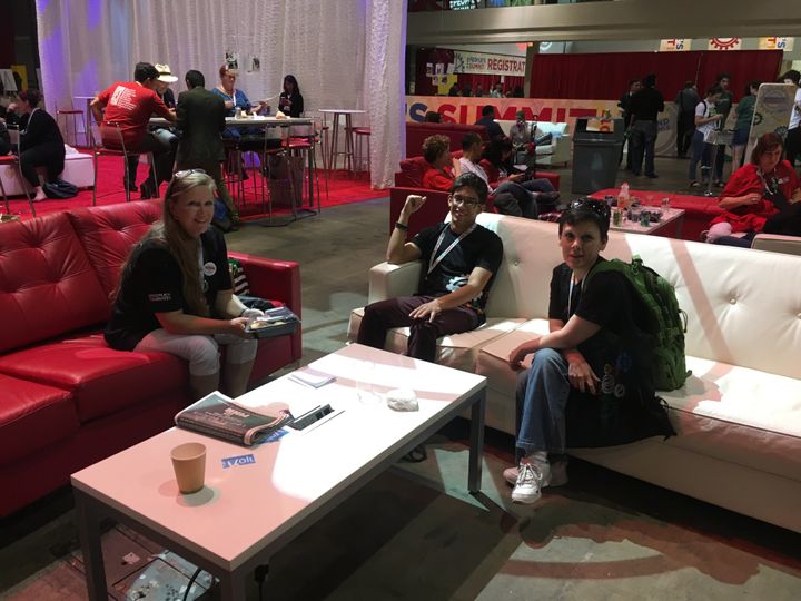 Antonio Rodriguez, center, chats with new friends Kellie Allen, left, and Jessica Cresseveur, right, in a lounge area at the People's Summit in Chicago on Sunday.