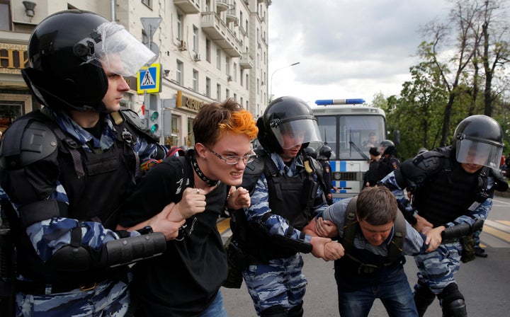 Police in riot gear arrest hundreds in cities across Russia on Monday during anti-Kremlin protests.