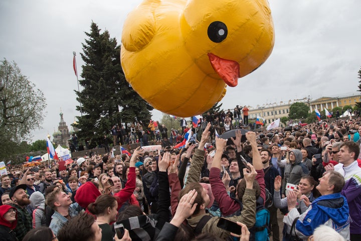 Protesters in St. Petersburg toss a giant yellow duck meant to symbolize a corruption investigation of Prime Minister Dmitry