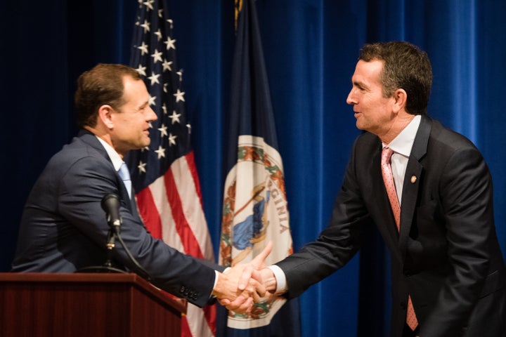 Tom Perriello, left, shakes hands with Lt. Gov. Ralph Northam at the start of their first head-to-head debate in Fairfax, Vir