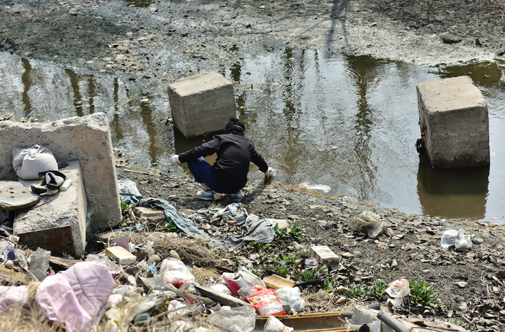 Taking water samples from a ditch on the north side of the Shandong Helon Chemical Fiber plant.