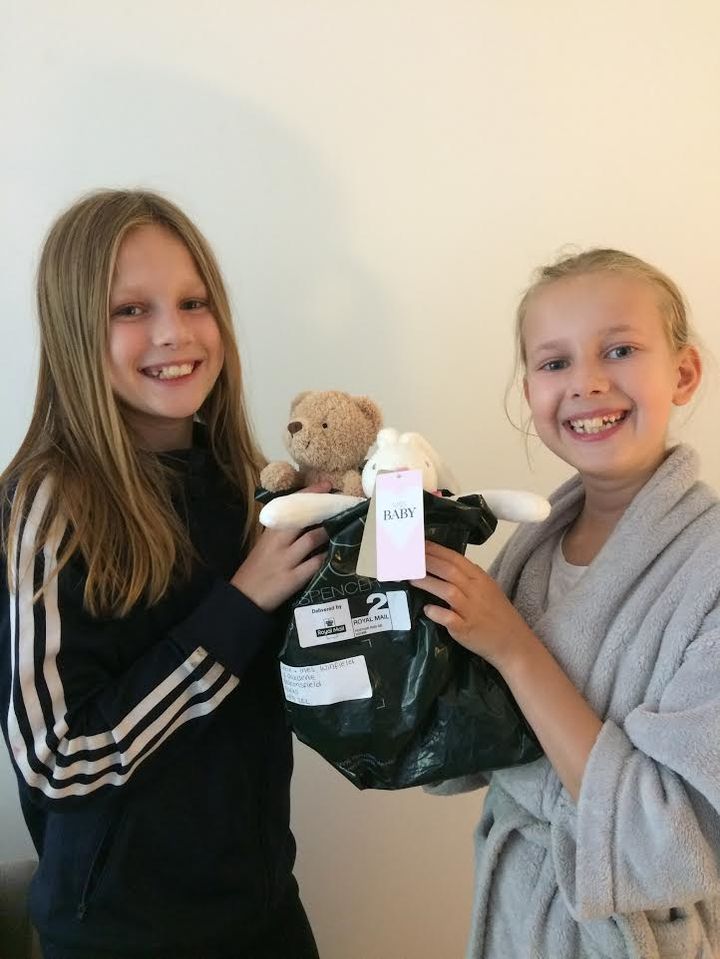 Lexie and Ines with a donation from M&S to The Pyjama Fund.