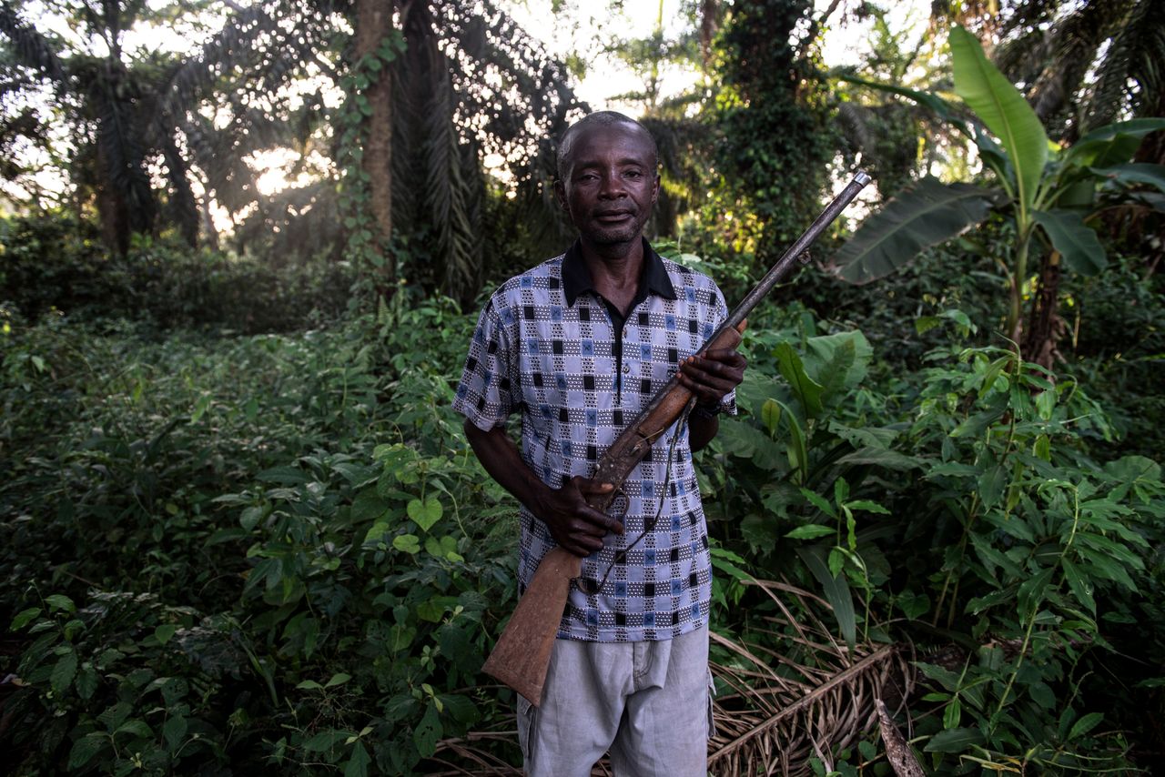 Jean-Marie Pongomoke poses with the gun he uses to hunt antelope outside his village of Salambongo in the Congolese bush.