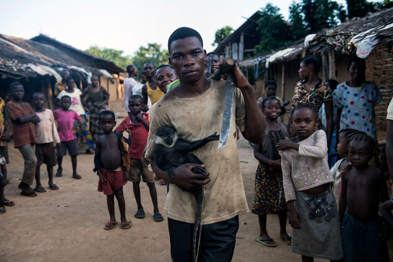 A resident of Salambongo with a monkey he caught and hopes to domesticate and sell.