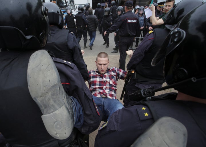 Riot police detain a demonstrator during an anti-corruption protest in central St. Petersburg, Russia, June 12, 2017.