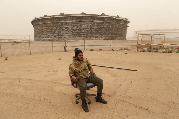 A soldier from the Libyan National Army guards oil tanks after they were recaptured from rebel fighters on March 16 2017.
