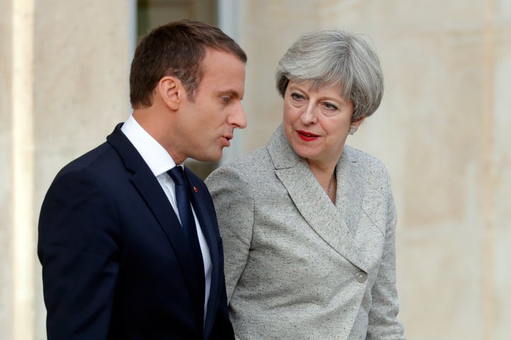 French President Emmanuel Macron escorts Britain's Prime Minister Theresa May as they arrive to speak to the press at the Ely