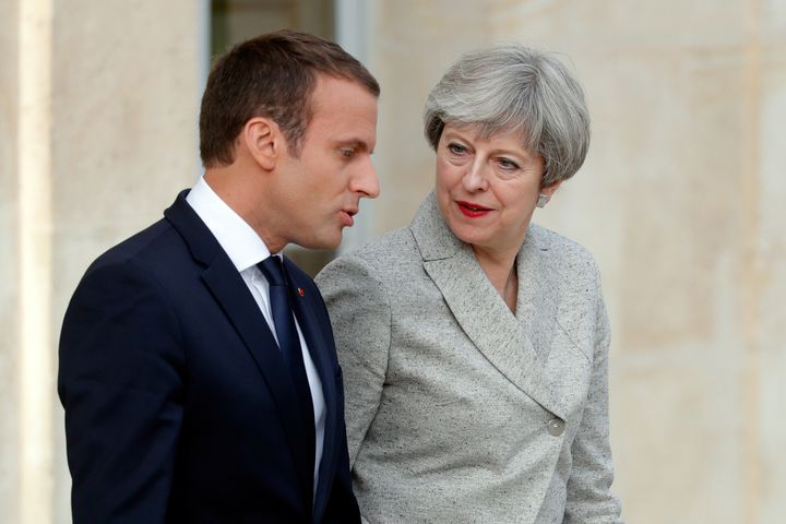 French President Emmanuel Macron escorts Britain's Prime Minister Theresa May as they arrive to speak to the press at the Elysee Palace in Paris. 